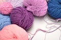 Colored balls of yarn. Shades of violet, purple, crimson, blue.