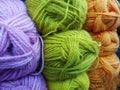 Variegated, bright and colorful yarns for knitting on shop shelf partially out of focus