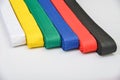 Colored belts in martial arts, for an almost gray background Royalty Free Stock Photo