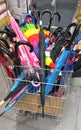 Colored and black umbrellas in a metal basket