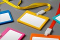 Colored blank nametags on strings on gray background Royalty Free Stock Photo