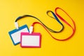 Colored blank nametags on strings on yellow background Royalty Free Stock Photo