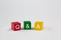 Colored blocks against an isolated white background contain the letters Q & A, which stand for Questions and Answers. Free space i Royalty Free Stock Photo