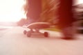 Colored blurred shot of male skateboarder's feet while skateboarding