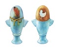 Colored boiled easter egg in blue egg cups holder. Hand painted watercolor illustration isolated on white background.