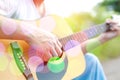 Colored bokeh image of male hand playing on acoustic guitar Royalty Free Stock Photo