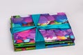 Colored books in a stack. Children`s books in a gift ribbon. Bright colorful little books for children.