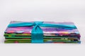 Colored books in a stack. Children`s books in a gift ribbon. Bright colorful little books for children.