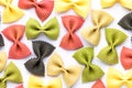 Colored bow tie pasta. Closeup multiple farfalle on white background