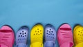 Colored bright slippers for women and children flip flops on a blue background. Place for text Royalty Free Stock Photo