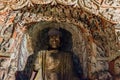 Colored Buddha statue in a niche of Cave 6 at Yungang Grottoes Royalty Free Stock Photo