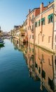 Colored buildings reflection of Vena canal in Chioggia - Italy Royalty Free Stock Photo