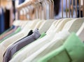 Colored business shirts on hangers in row. Royalty Free Stock Photo