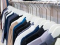 Colored business shirts on hangers in row. Royalty Free Stock Photo