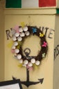 Colored butterflies on easter wreath from egg shells on wall