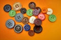 Buttons sewing on an orange background