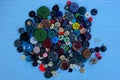 Colored buttons on a heap on a blue table