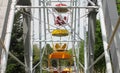 colored cabins of a ferris wheel in a city park