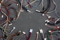 Colored cables and wires with connectors on gray concrete background. Telecommunications. Blank for postcard Royalty Free Stock Photo