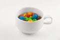 Colored candies in a white cup Royalty Free Stock Photo