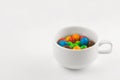 Colored candies in a white cup Royalty Free Stock Photo