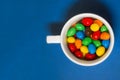 Colored candies in a white cup Royalty Free Stock Photo