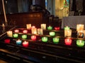 Colored candles lit inside the Basilica of St Michel in Bordaux France