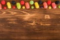 Colored candy on dark wooden background with copespace