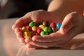 Colored candys, sugar, much, non healtly in the hands of a child