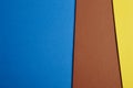 Colored carboards background in blue, brown, yellow tone. Copy s