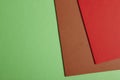 Colored cardboards background in green brown red tone. Copy space