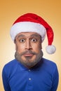 The colored caricature of the funny santa clause with big head and blue shirt, red hat with gray beard, surprised looking Royalty Free Stock Photo