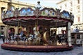 Colored carousel with ponies but without children riding in Florence.