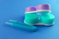 Colored cases for contact lenses for eyes on a blue background. Royalty Free Stock Photo