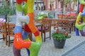 Colored ceramic mosaic decoration on a gray sidewalk in front of wooden brown chairs and a table on an open summer veranda Royalty Free Stock Photo