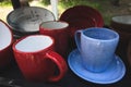 colored ceramic mugs on a wooden shelf Royalty Free Stock Photo