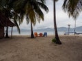 Colored chairs on the beach at Ina Island San Blas Panama, mountain range on the horizon