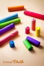 Colored chalk on a beige paper background Royalty Free Stock Photo