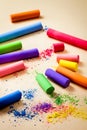 Colored chalk on a beige paper background Royalty Free Stock Photo