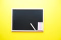 Colored chalk on a dark school board on the yellow background. Back to school concept. Place for your text Royalty Free Stock Photo