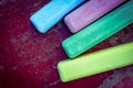 Colored chalk sticks on old wood board as copy space background Royalty Free Stock Photo