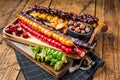 Colored Churchkhela Georgian sweets with Walnuts and hazelnuts. Wooden background. Top view