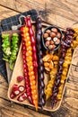 Colored Churchkhela Georgian sweets with Walnuts and hazelnuts. Wooden background. Top view