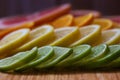 Colored citrus slices. Green lime, yellow lemon, orange orange and red grapefruit sliced lie on the table. Fruit composition