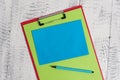 Close up front view colored clipboard blank paper sheet sticky note marker lying retro old wooden rustic vintage