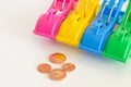 Colored clothespins and coins Royalty Free Stock Photo