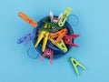 Colored clothespins in the container on the blue background Royalty Free Stock Photo