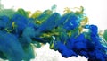 Colored cloud of ink on a white background. Blue, green and yellow watercolor ink in water on a white background. Beautiful Royalty Free Stock Photo