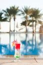 Colored cocktails on a background of water. Colorful cocktails near the pool. Beach party. Summer drinks. Exotic drinks. Glasses o Royalty Free Stock Photo