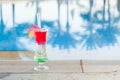 Colored cocktails on a background of water.